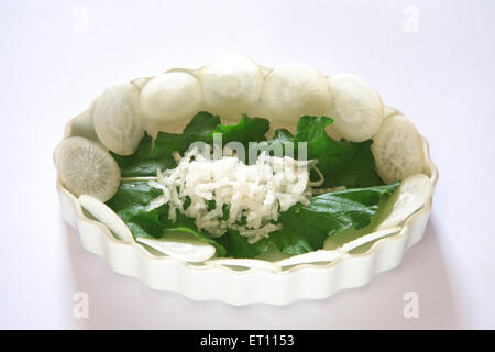 Green vegetable ; round slices of muli radish raphanus sativa with green leaves on white background Stock Photo