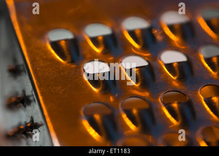 Macro-photo of a section on a mini cheese grater / hand grater / box grater. Abstract metal texture. Stock Photo
