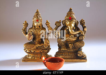 Diwali deepawali festival ; shree lakshmi puja with god ganesh ; oil lamp ; India Stock Photo