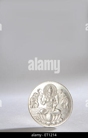 Silver coin with goddess Lakshmi picture ; India Stock Photo