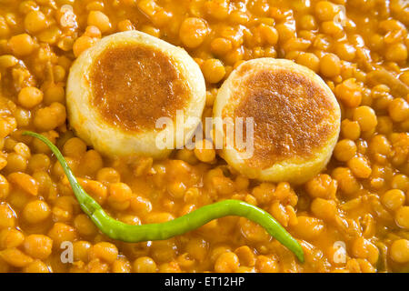 Indian fast food chaat chickpeas chhole ragda potatoes patties with green chilli india Stock Photo