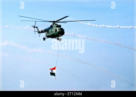Indian Navy helicopter flying with National Flag on Air Force Day ; Trivandrum ; Thiruvananthapuram ; Kerala ; India Stock Photo