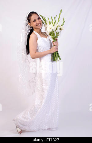Christen bride in white gown and veil holding flowers MR#733C Stock Photo