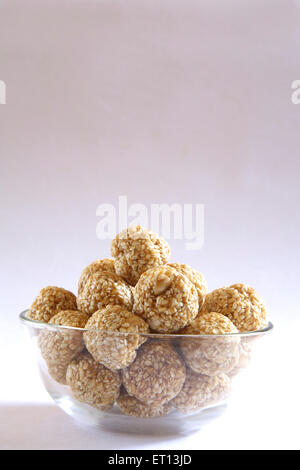 Makar Sankranti festival , sweet tilgur ladoo , tilgul ladoo , sesame ladoo , in bowl on white background , Makara Sankranti festival , India Stock Photo