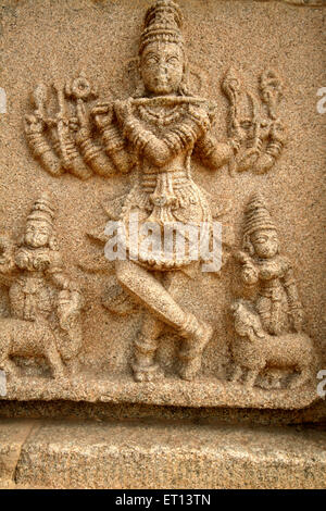 Lord Krishna playing flute stone relief statue ; Hampi ; Karnataka ; India Stock Photo