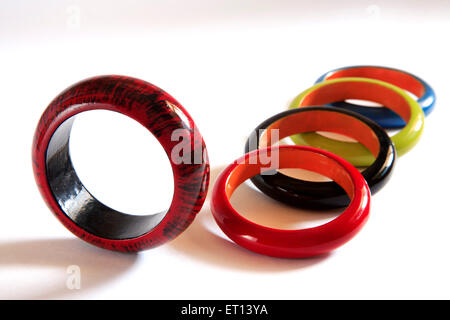 Colorful wooden bangles on white background Stock Photo