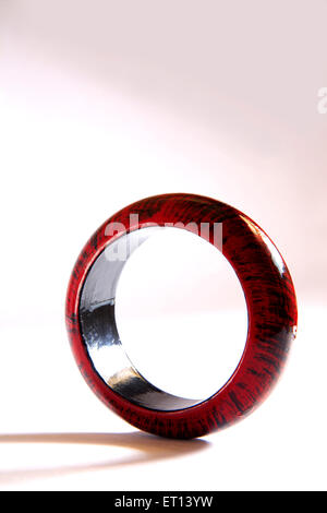 Maroon and black colors on wooden bangle on white background Stock Photo