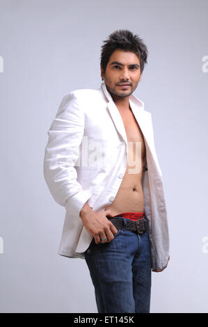Man in blue jeans and open white coat MR#719G Stock Photo