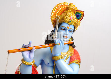 Clay statue of god krishna playing flute Stock Photo