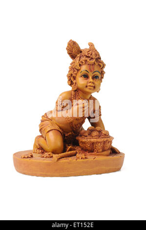 Bal Krishna, Bal Gopal, Ladoo Gopal, Baby Krishna clay statue on white background, India, Asia Stock Photo