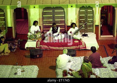 Musicians playing musical instruments harmonium tabla sitar ; Bikaner ; Rajasthan ; India Stock Photo