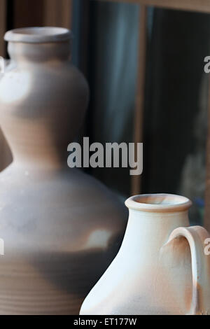 Two ceramic vases against rustic wooden windows Stock Photo