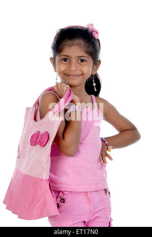 Girl in pink dress with matching color shopping bag MR#736M Stock Photo