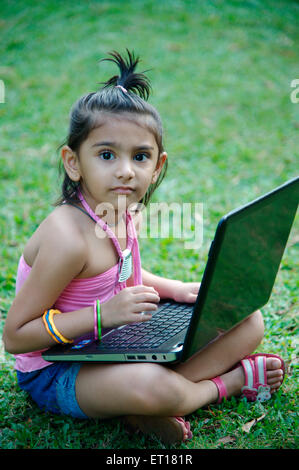 Baby girl working on laptop computer MR#736L Stock Photo