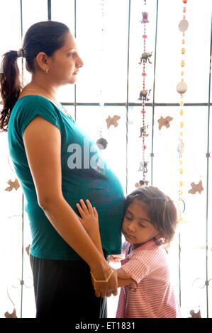 Child listening coming baby pregnant woman - MR#736K Stock Photo