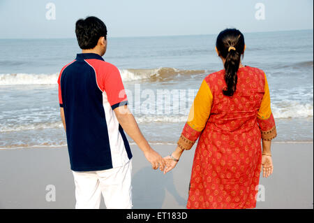 Indian Young Couple walking on Beach MR#736J MR#736K Stock Photo