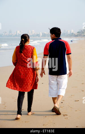Indian Young Couple walking on Beach MR#736J MR#736K Stock Photo