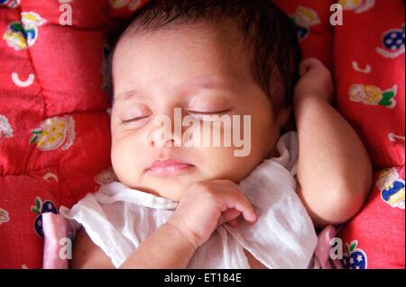 Indian baby girl child sleeping red background - MR#736LA - rmm 179684 Stock Photo