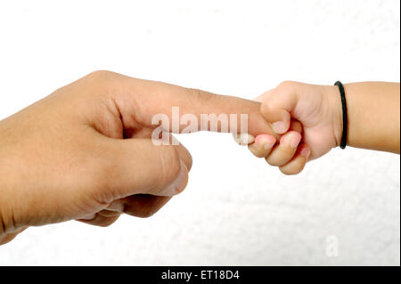 Baby holding finger MR#736K&LA Stock Photo