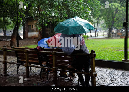 Romance Young Couple Enjoying Monsoon Rain in The Garden Stock Photo