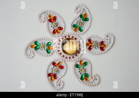 Mango Shape Rangoli Made of Pearls on White Background Stock Photo - Alamy