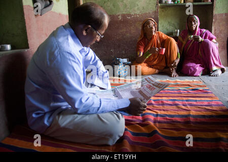 Man reading newspaper in house ; Salunkhewadi ; Nandur ; Marathwada ; Maharashtra ; India MR#688 Stock Photo