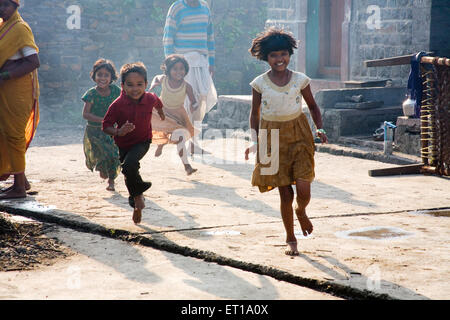 Children running in street ; Salunkhewadi ; Nandur ; Marathwada ; Maharashtra ; India ; Asia ; MR#688 Stock Photo