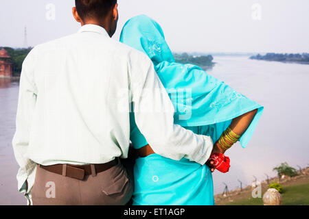 Indian tourist couple looking at the Yamuna river ; Taj Mahal ; Agra ; Uttar Pradesh ; India Stock Photo