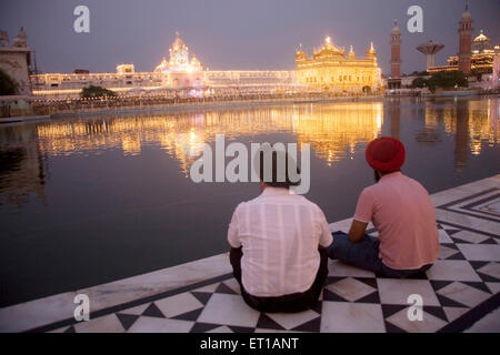 Two Sikh religion men looking decorated Hari mandir Sahib Dussera festival ; Swarn Mandir Golden temple ; Amritsar Stock Photo