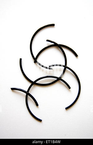 Broken black color glass bangles on white background Stock Photo