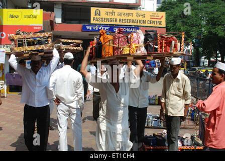 Dabbawala carrying lunchboxes in  tray at churchgate station ; Bombay Mumbai ; Maharashtra ; India NO MR Stock Photo