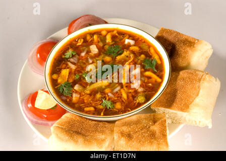 Snacks ; misal pav with tomatoes slices served in plate Stock Photo