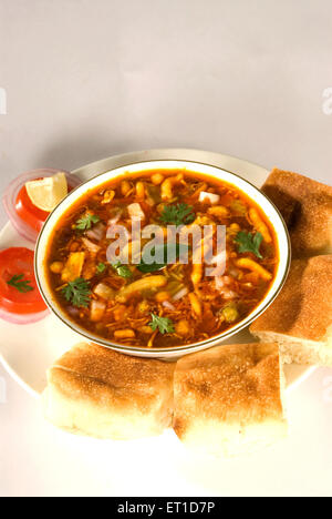 Misal pav with tomato slices served in plate Stock Photo