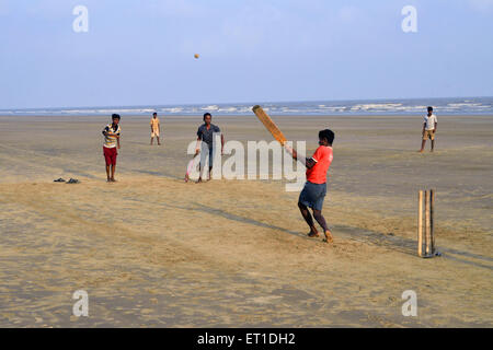 Boys playing cricket on the beach of Mandarmoni Kolkata West Bengal India Asia Stock Photo