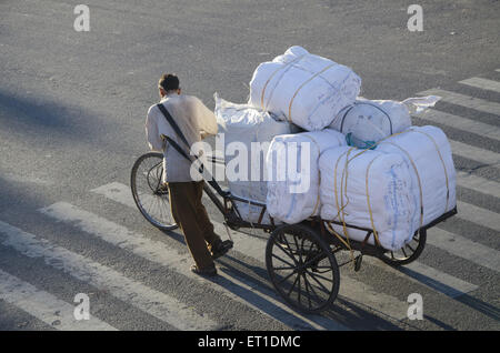 Rickshaw driver dragging cycle rickshaw in Jaipur at Rajasthan India Stock Photo