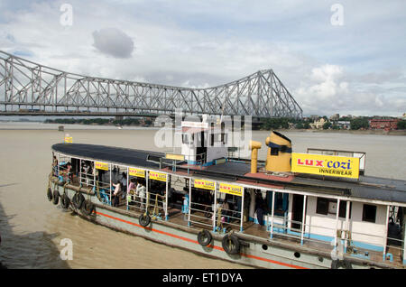 Boat in Hooghly river and howrah bridge in Kolkata at West Bengal India Asia Stock Photo