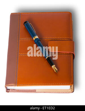 Fountain pen on top of the closed notebook isolated on white background Stock Photo