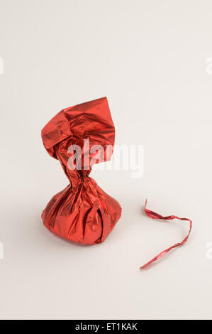 chocolate wrapping in red shiny paper Stock Photo