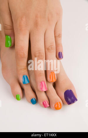 Different colours of nail polish on nails Pune Maharashtra India Asia May 2011 Stock Photo