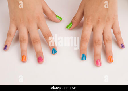 Different colours of nail polish on nails Pune Maharashtra India Asia May 2011 Stock Photo