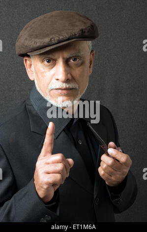 Portrait of maharashtrian elderly man holding smoking pipe in left hand Pune Maharashtra India MR # 686P Stock Photo