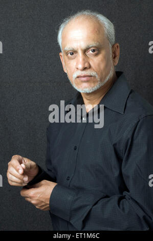 old man in black full sleeve shirt and buttoning cuffs - Model Release # 686P Stock Photo