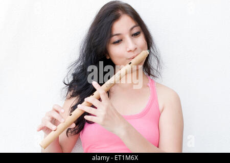 A portrait of maharashtrian girl playing a flute Pune Maharashtra India Asian MR # 686EE Stock Photo