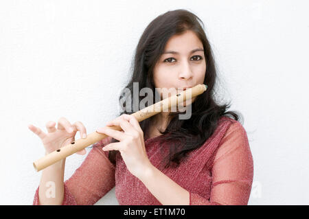 A portrait of maharashtrian girl playing a flute Pune Maharashtra India Asia MR # 686EE Stock Photo