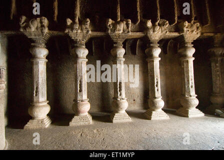 Richly carved pillars in Buddhist caves on mountain at Lenyadri ; taluka Junnar ; district Pune ; Maharashtra ; India Stock Photo