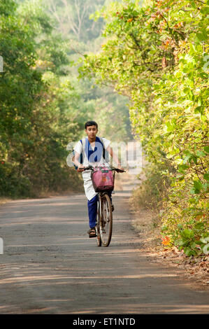 Young girl going school on bicycle in ; Lanja ; Ratnagiri ; Maharashtra ; India MR#556 Stock Photo