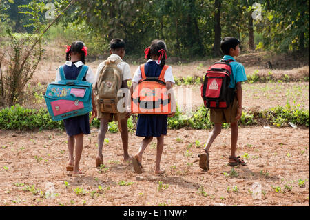 Students with heavy bags going to school in a village, Maharashtra, India, Asia, Indian, Asian Stock Photo