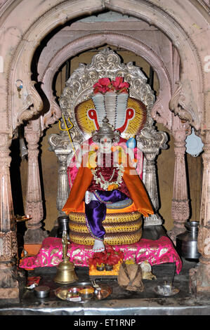 Idol of Lord Vishnu resting on sheshnag in hindu temple altar at phaltan satara Maharashtra India Asia Stock Photo