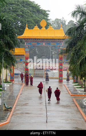 Buddhist Monk Escaping The Rain In Mundgod at Karnataka India Asia Stock Photo
