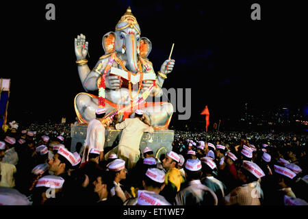 Idol of lord Ganesha (elephant headed god) ; Visarjan ceremony 2008 ; Girgaum Chowpatty beach ; Bombay Mumbai ; Maharashtra Stock Photo